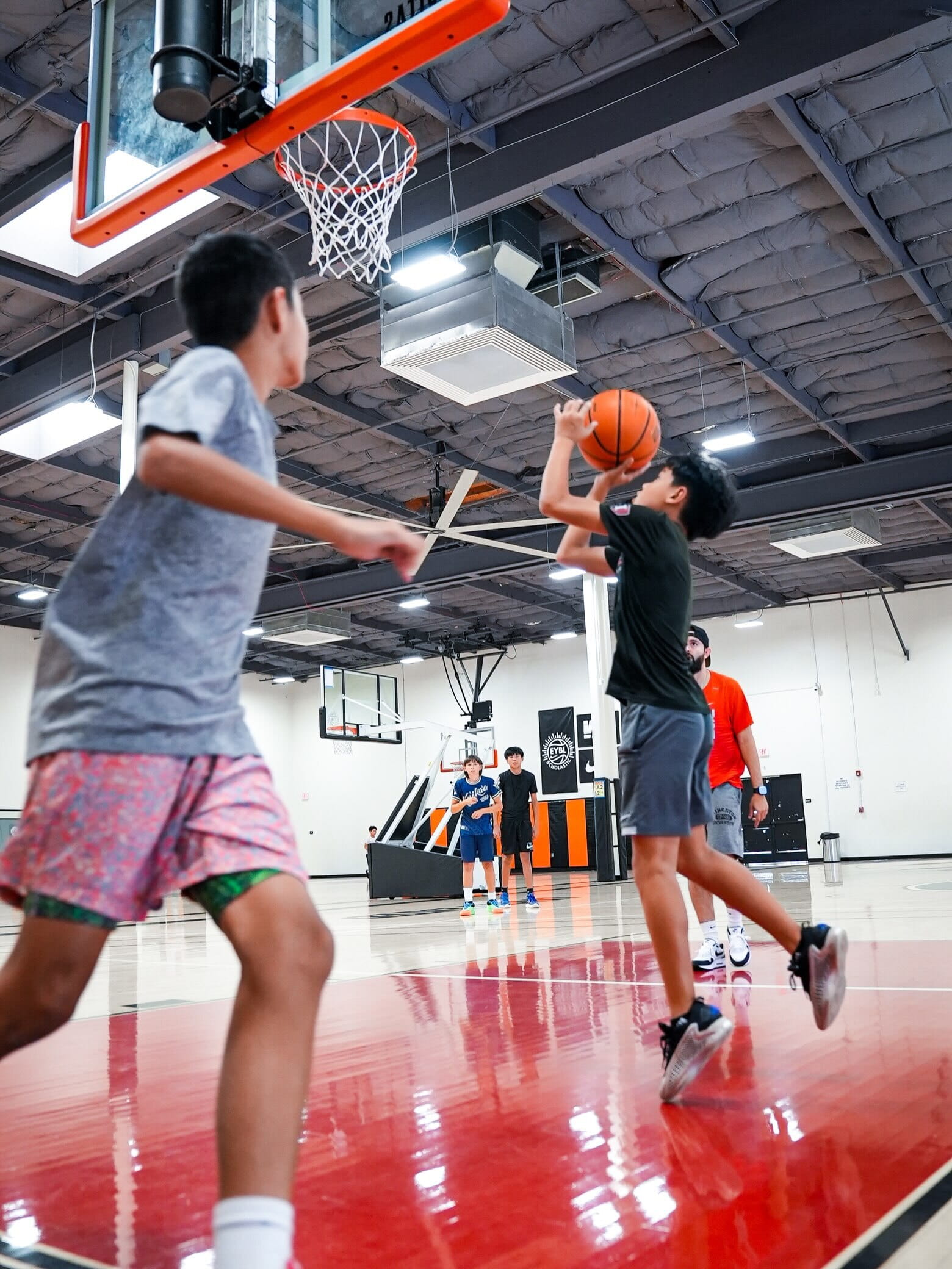 Athlete mid-jump during a shooting drill