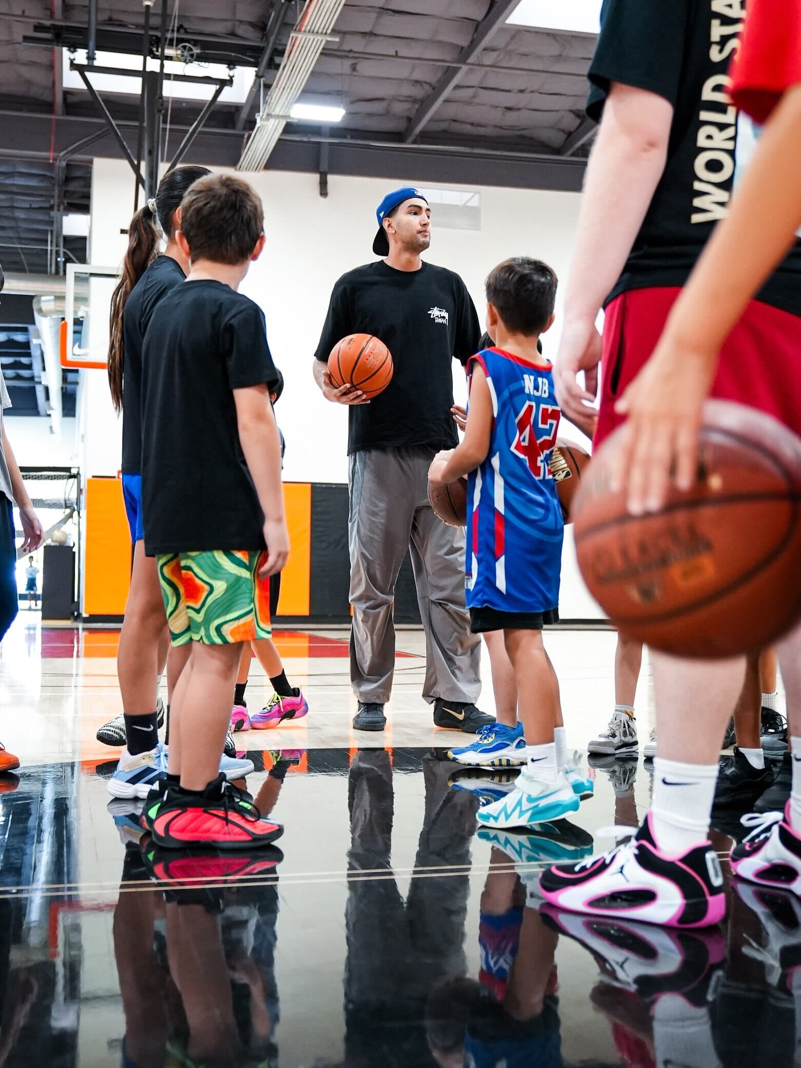 Coach instructing a semi-circle of young players