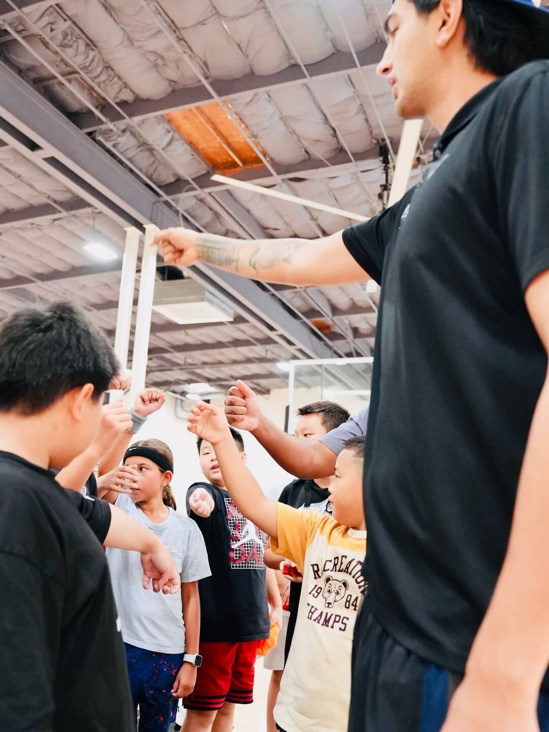 Coach huddling with young players before a game