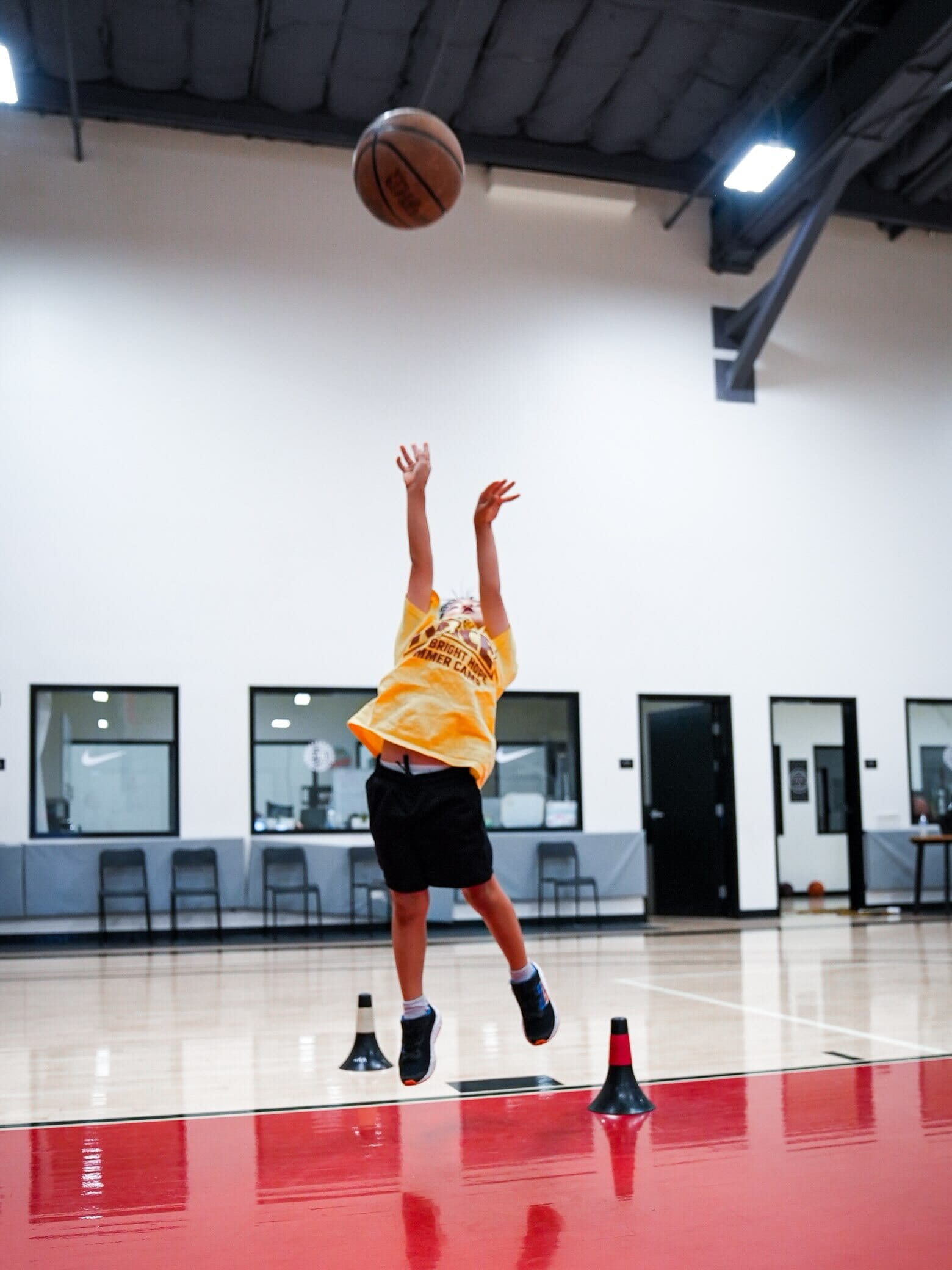 Young player reaching for the ball during a camp drill