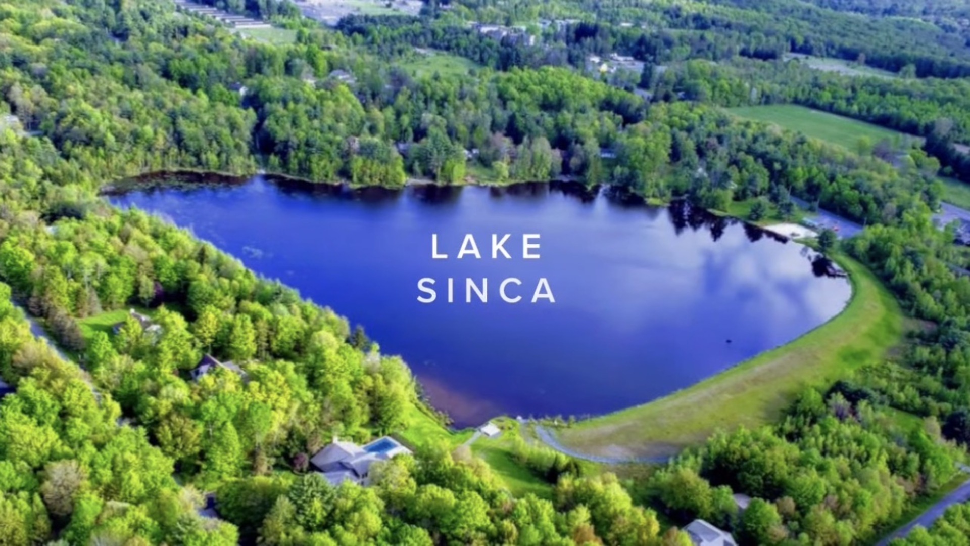 Aerial view of Lake Sinca surrounded by forest in Greenwood Acres, Blakeslee, Pennsylvania