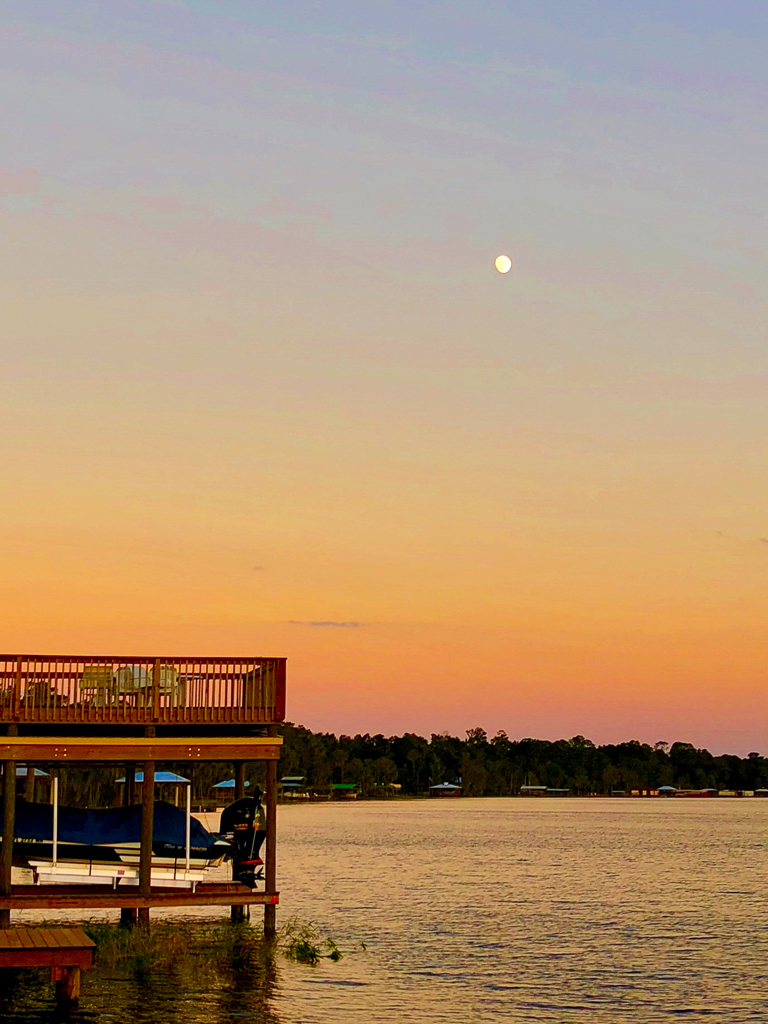 The cabin at sunset with the moon rising overhead