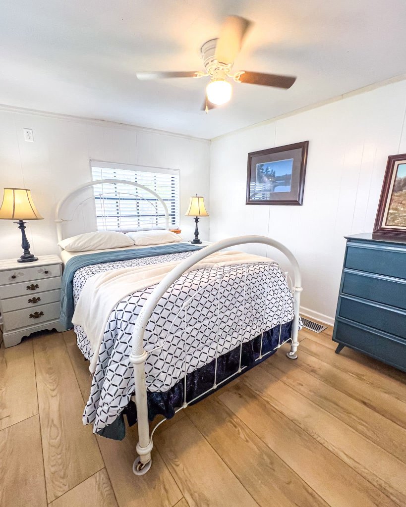 Queen bed with geometric bedding and lake breeze