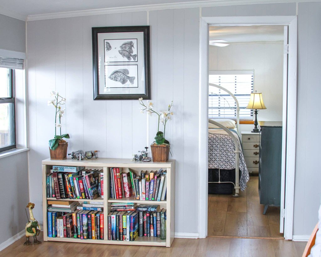 Cozy reading nook with bookcase and lake-view windows