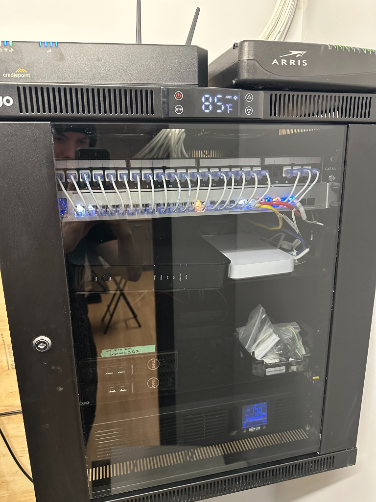 After — clean professional network rack with Cat6A patch panel