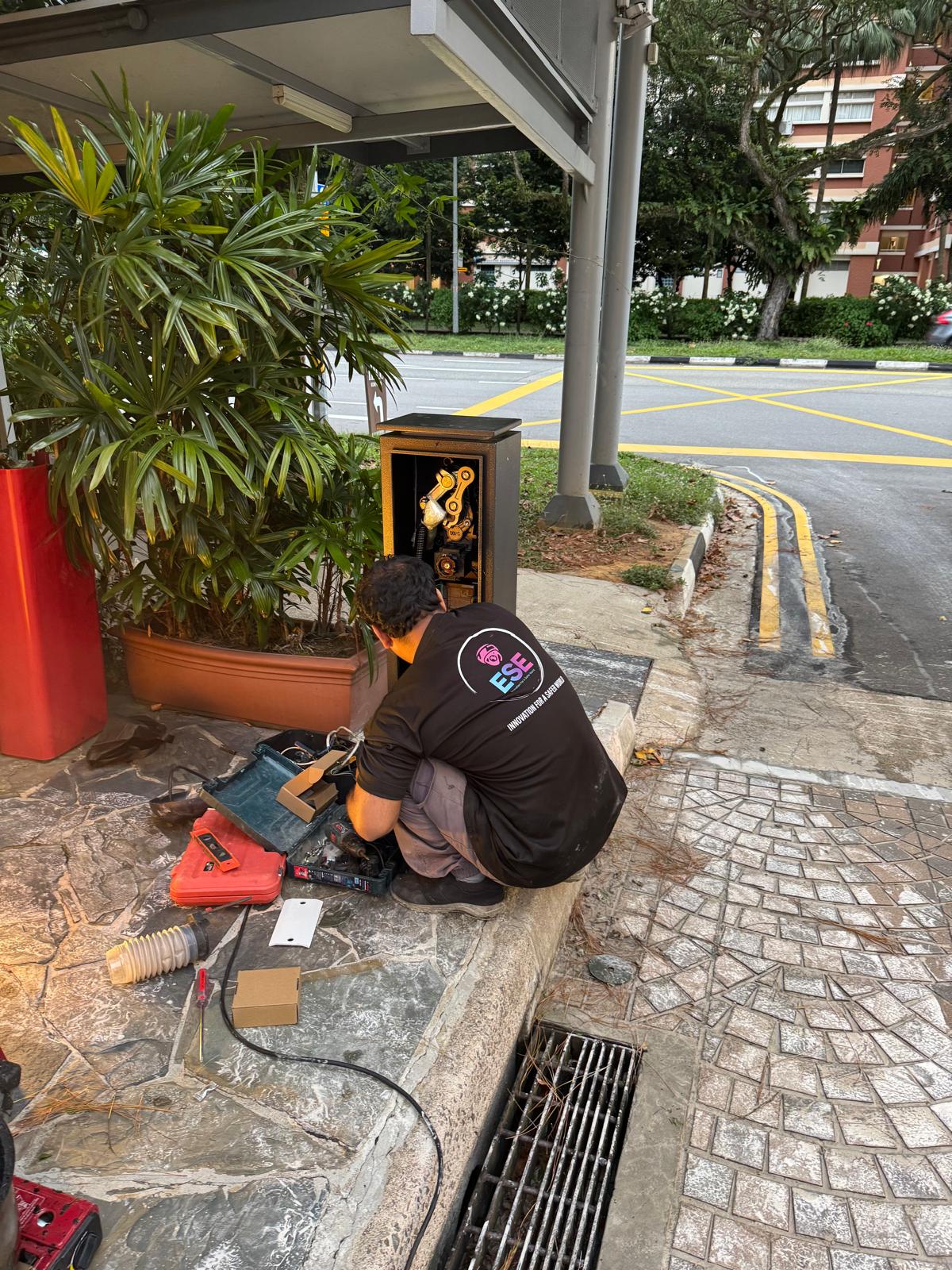 Replacement of New Gantry Barrier System — Technician Working on Barrier Housing