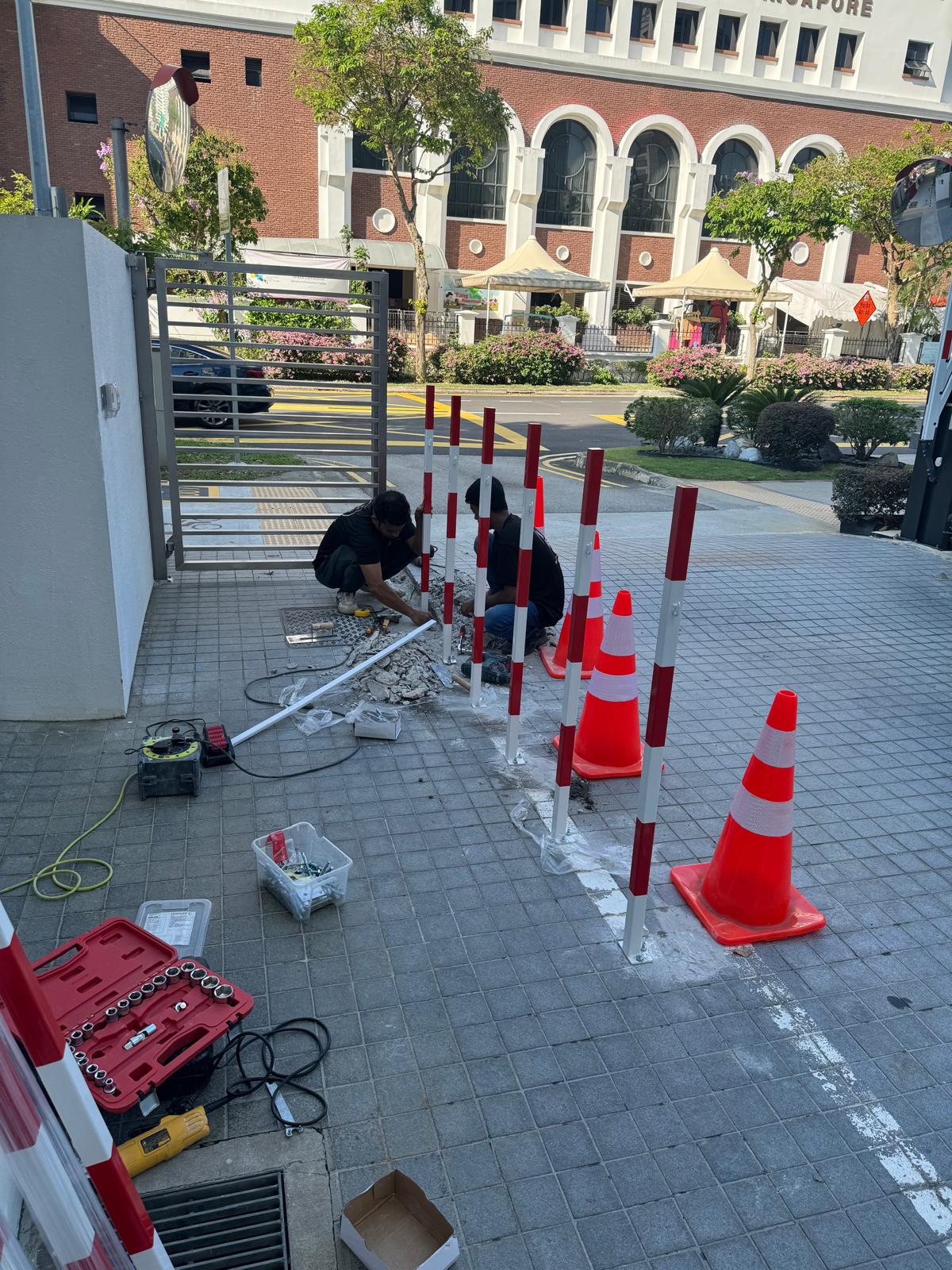 Parc Seabreeze Condo Integrated Security & Vehicle Access — Technicians Installing Safety Posts