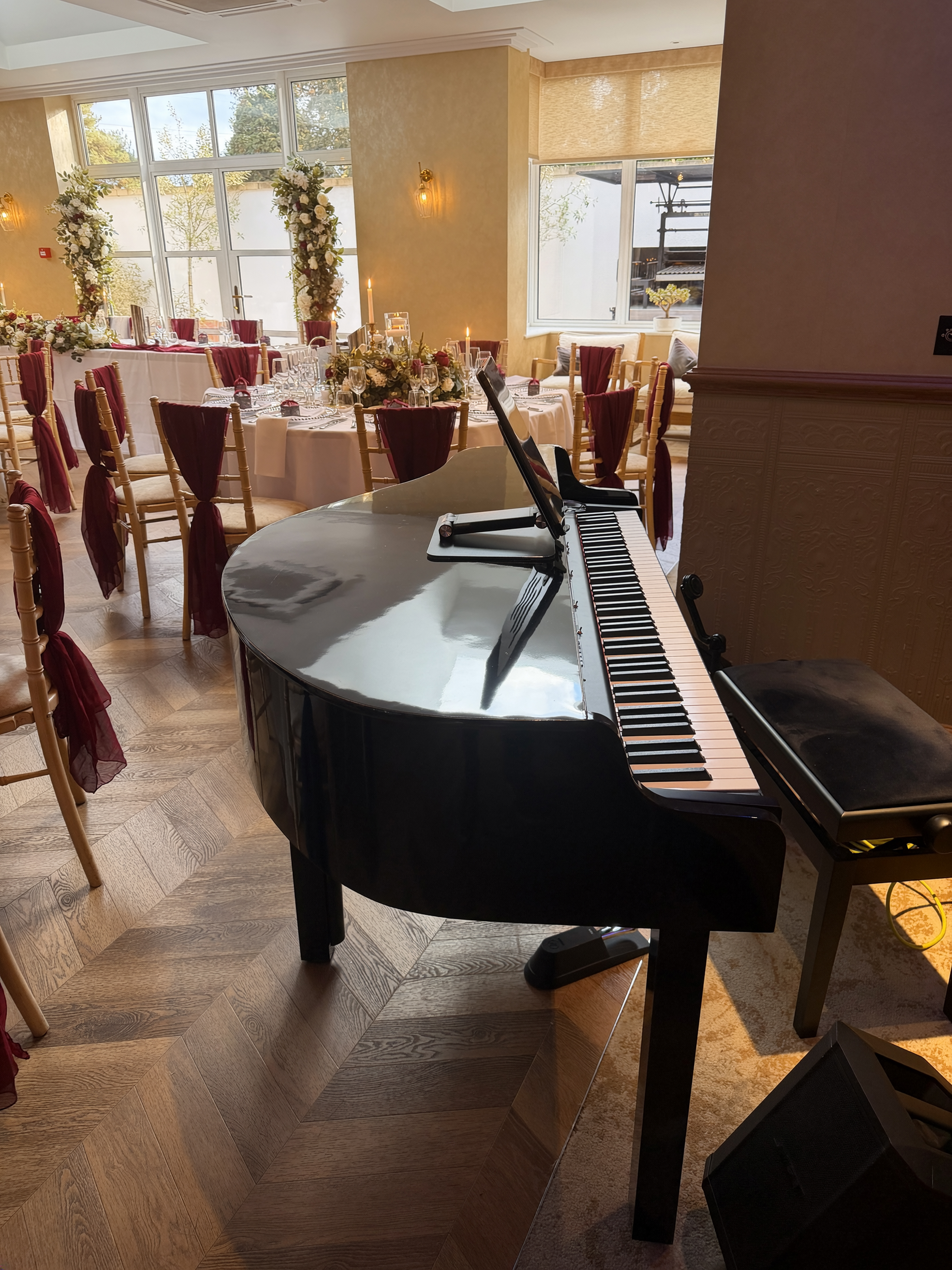 Rob's black baby grand piano set up in a wedding reception