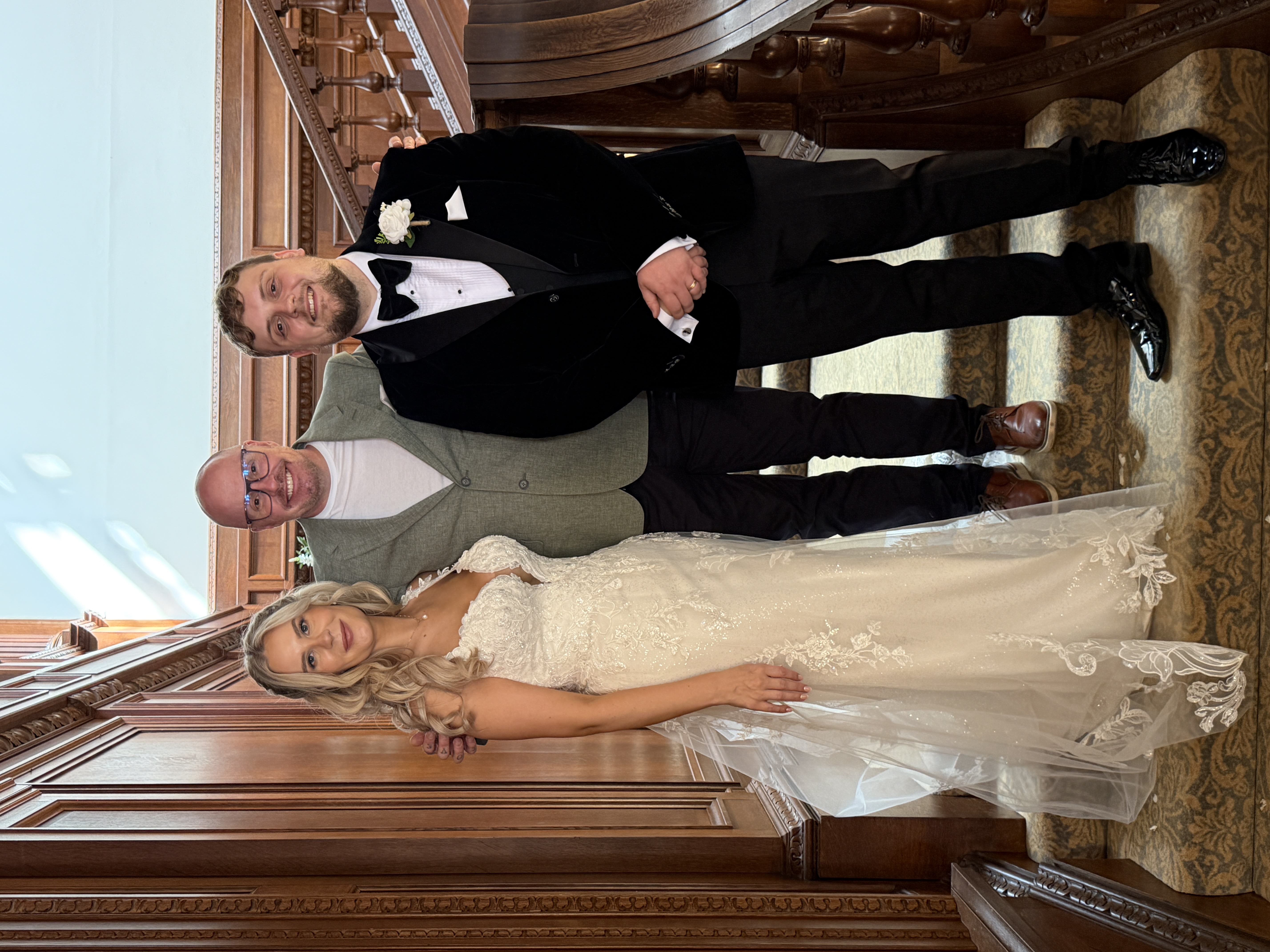 Rob Price with a wedding couple on the staircase