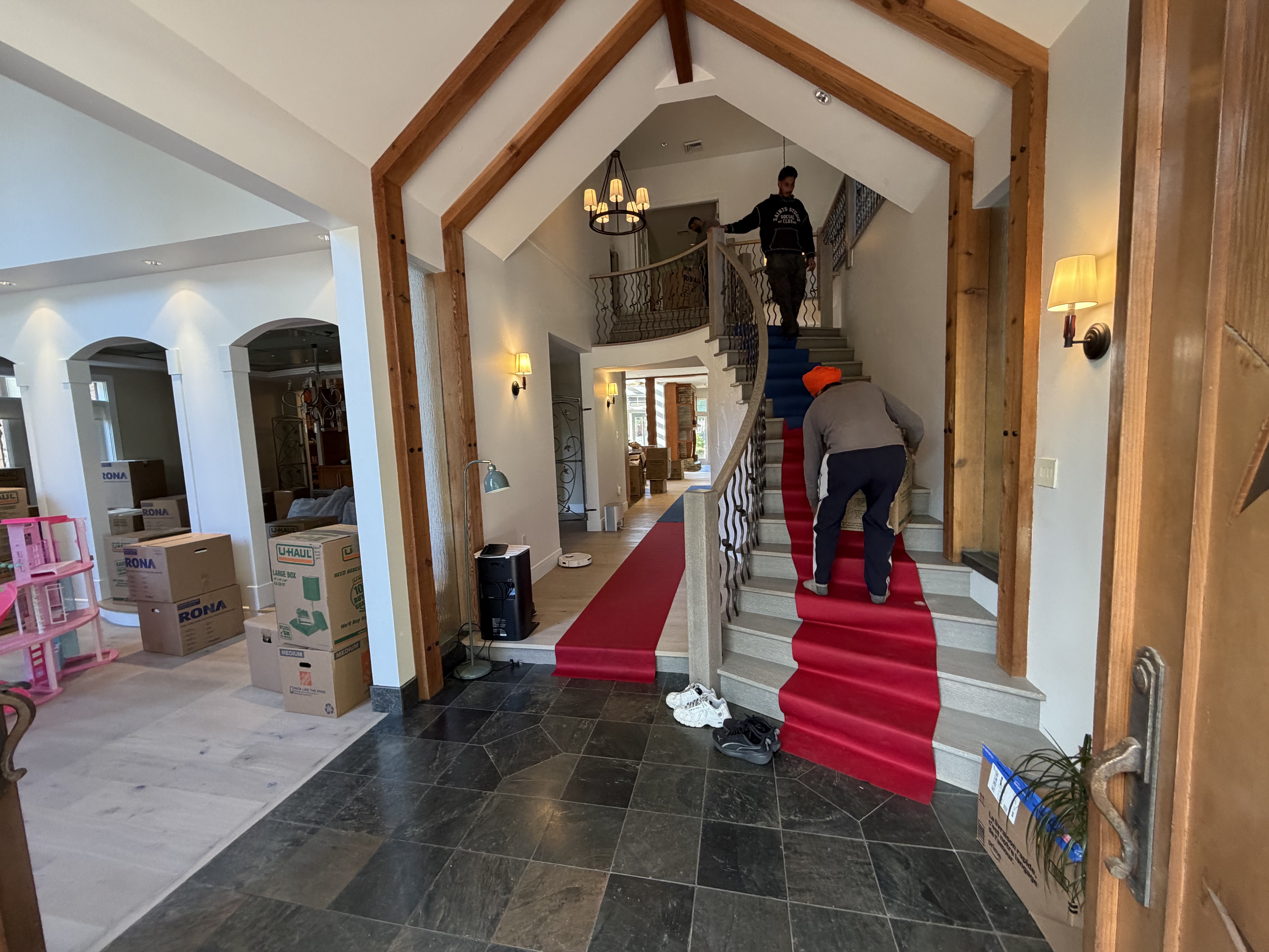 Floor runners down and stairs protected while boxes head up
