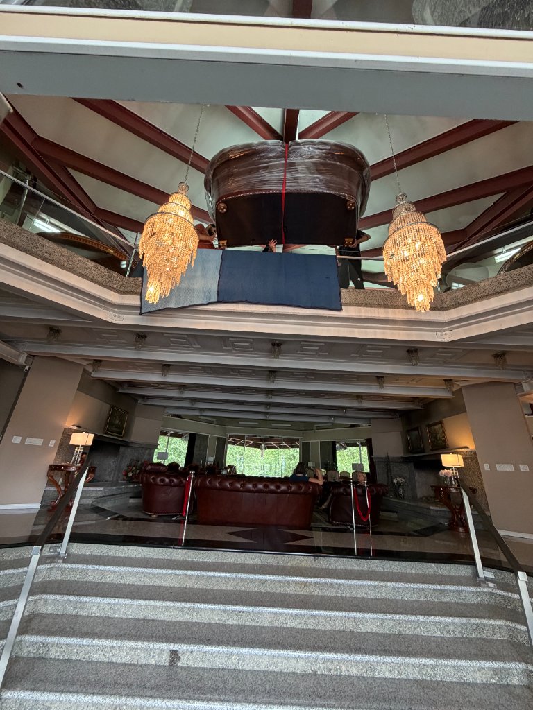 Oversized leather sofa safely maneuvered across a mezzanine staircase in a luxury home — zero damage
