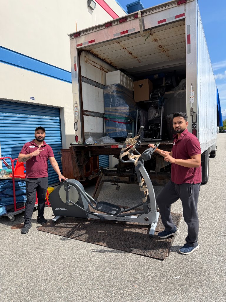 Movers loading an elliptical trainer