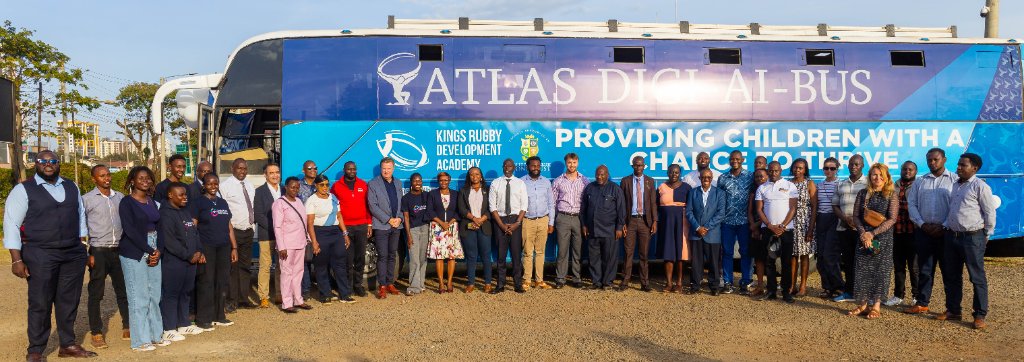 Team and partners lined up in front of the Atlas Digi AI Bus