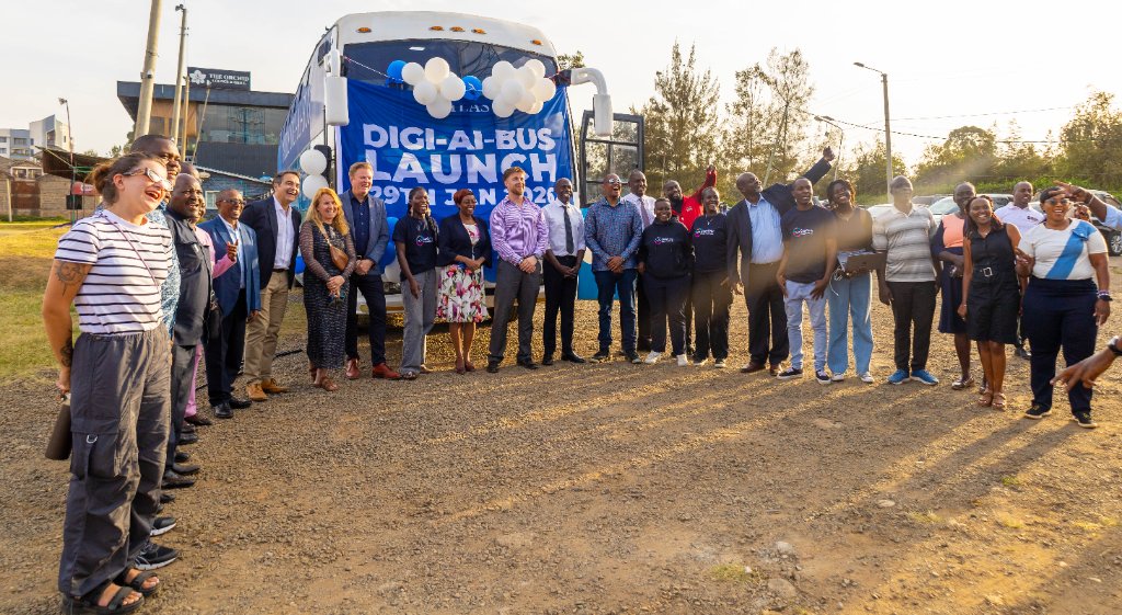 Launch day group photo in front of the Digi AI Bus banner