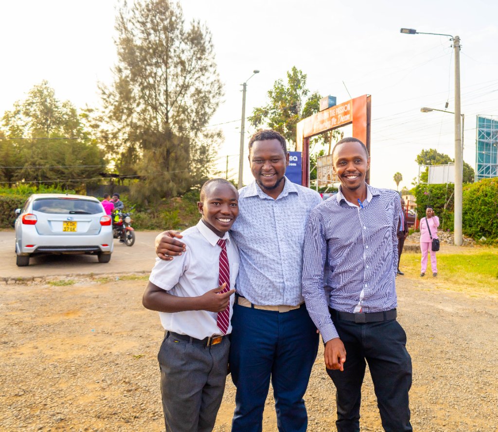 Three smiling attendees at the Digi AI Bus launch event
