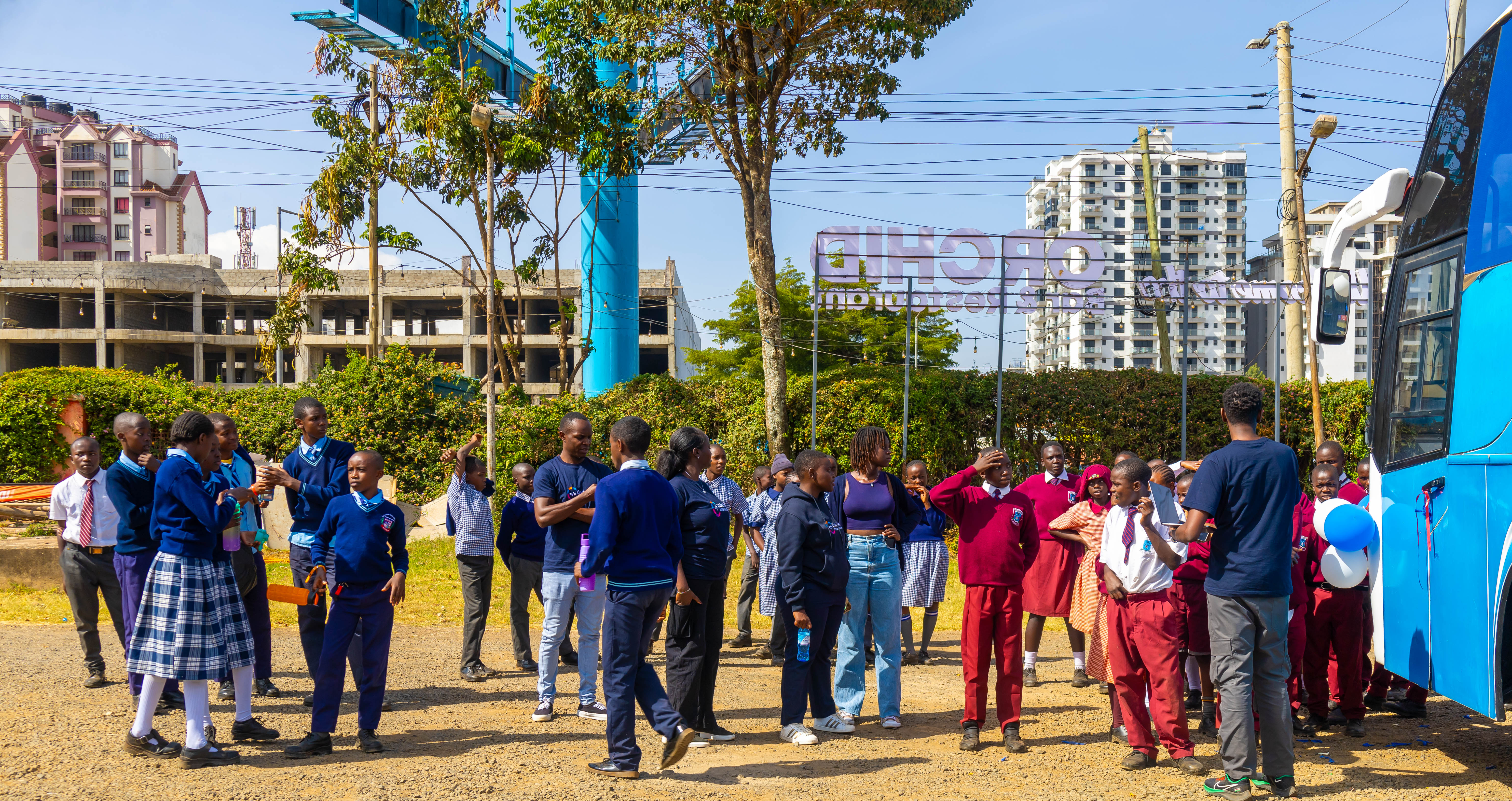 Students in school uniforms gathered outside the Digi AI Bus