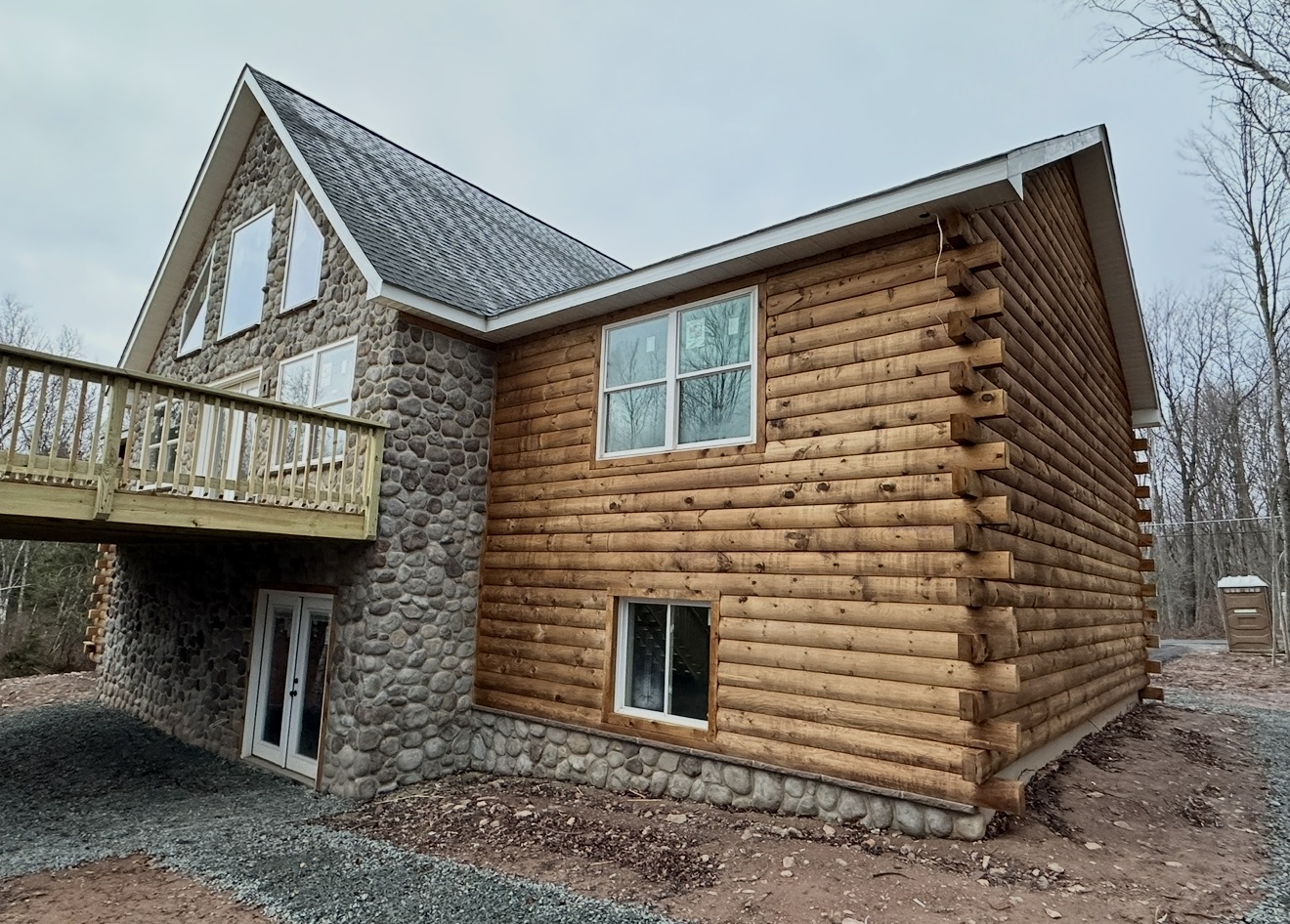 Log home with stone center gable