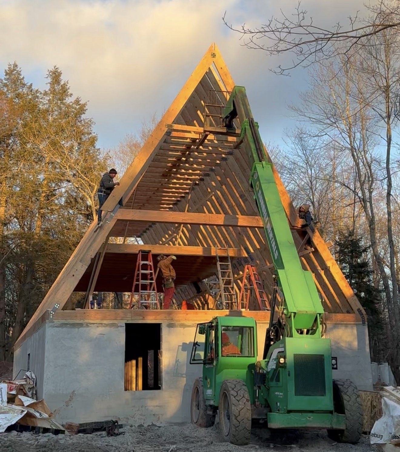 A-frame framing in progress at sunset