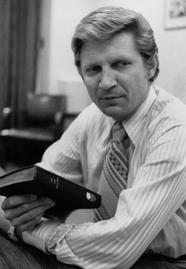 David Wilkerson, founder of Teen Challenge, seated with a Bible