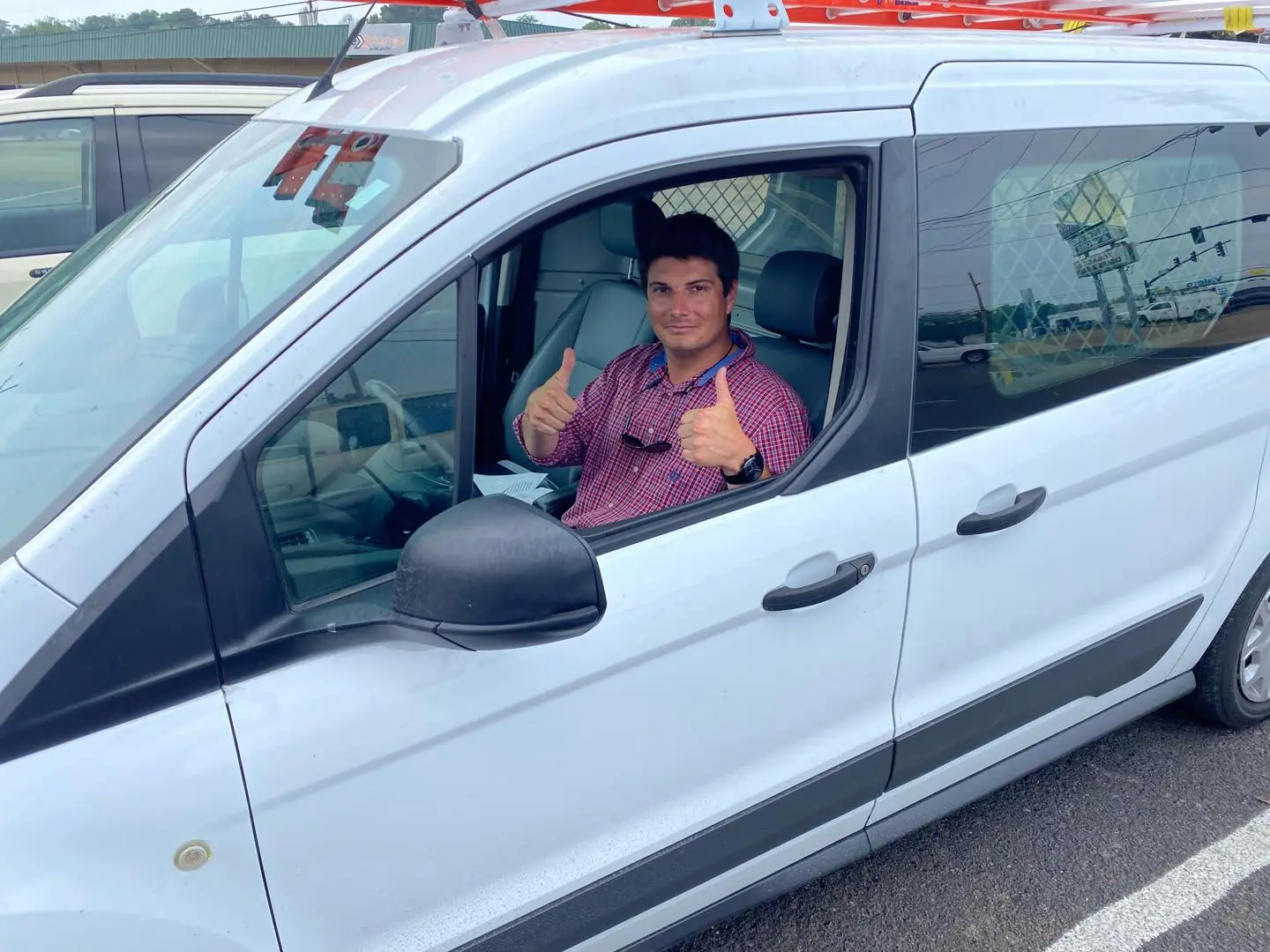 Mercy House alumnus giving a thumbs up in his work van