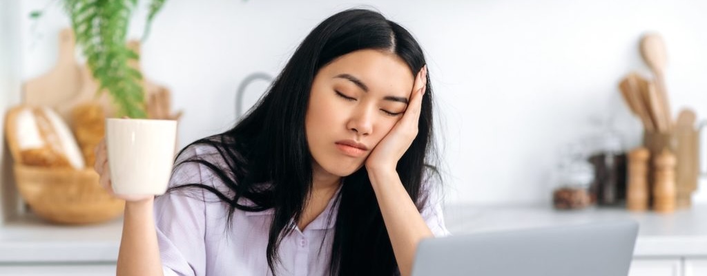 Person looking exhausted at their desk