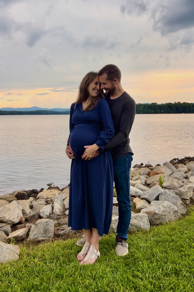 Expecting couple by the lake