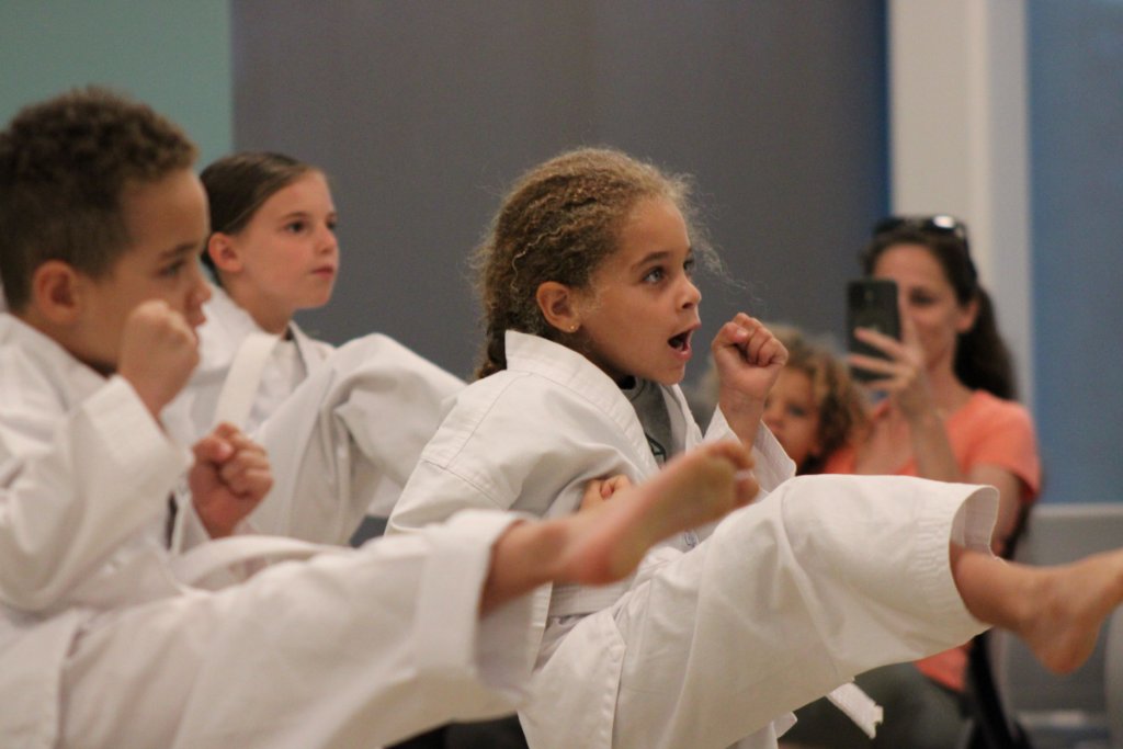 Young students practicing kicks in class at Yeshá Taekwondo Palm Coast