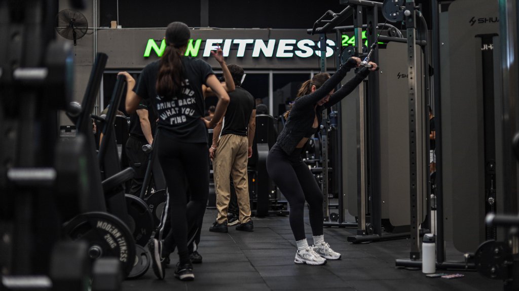 Socia en polea con logo NOW FITNESS 24/7
