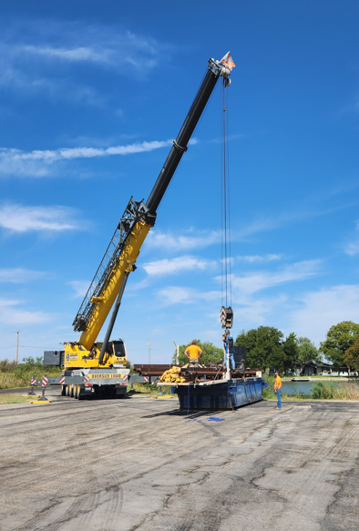 Large crane lifting IET barge drilling platform for waterway deployment