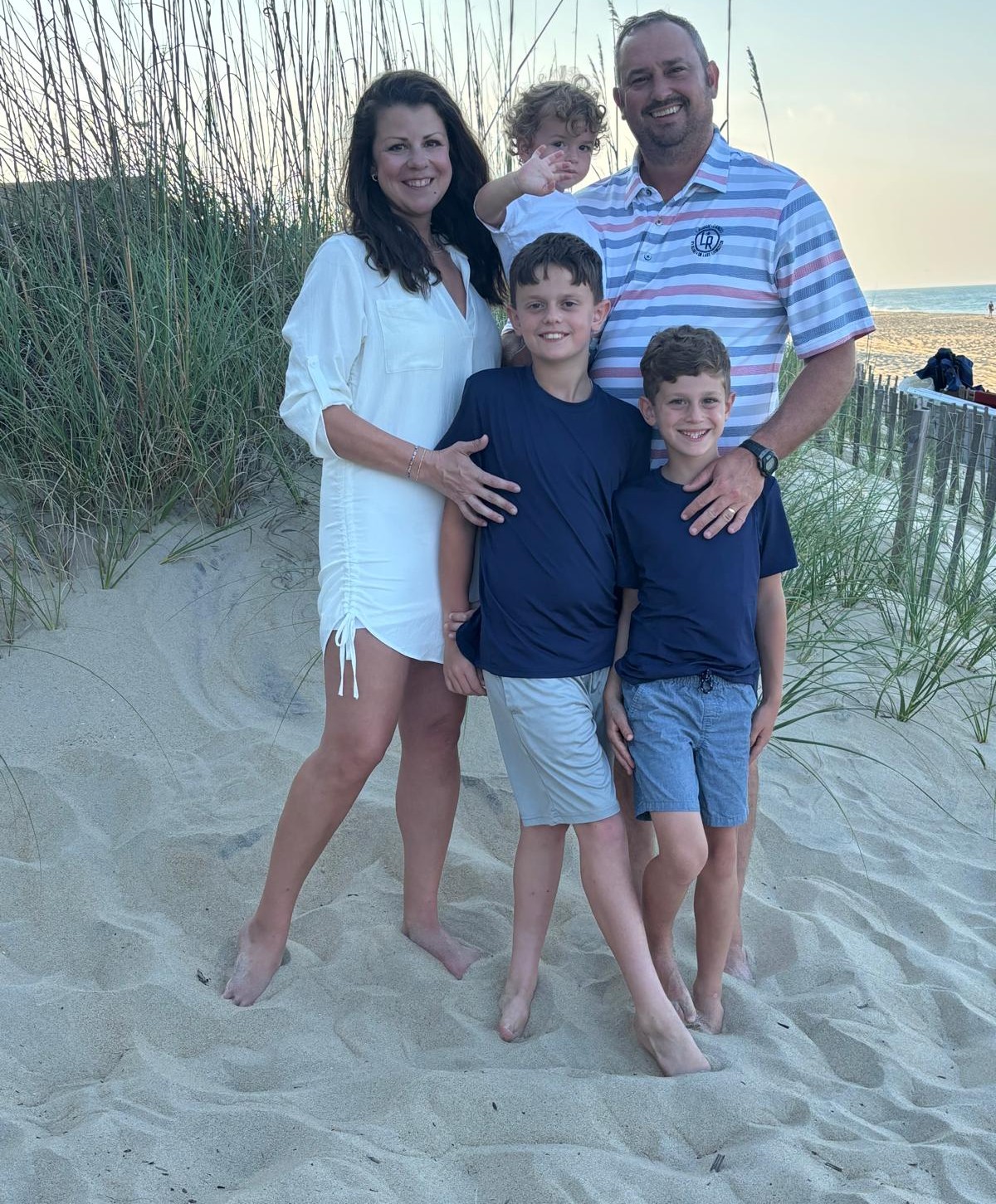 Justin Grimes with his family on the beach at sunset