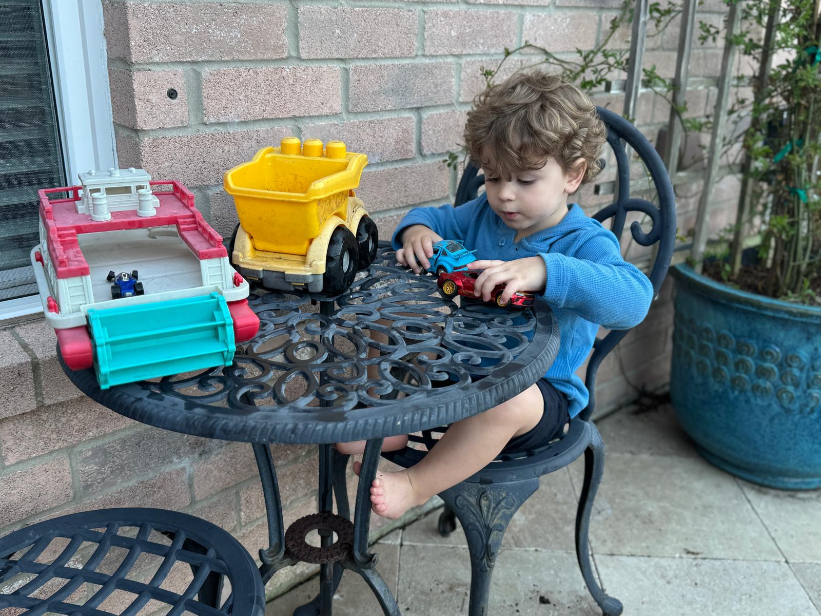 One of Justin's sons playing with toy cars