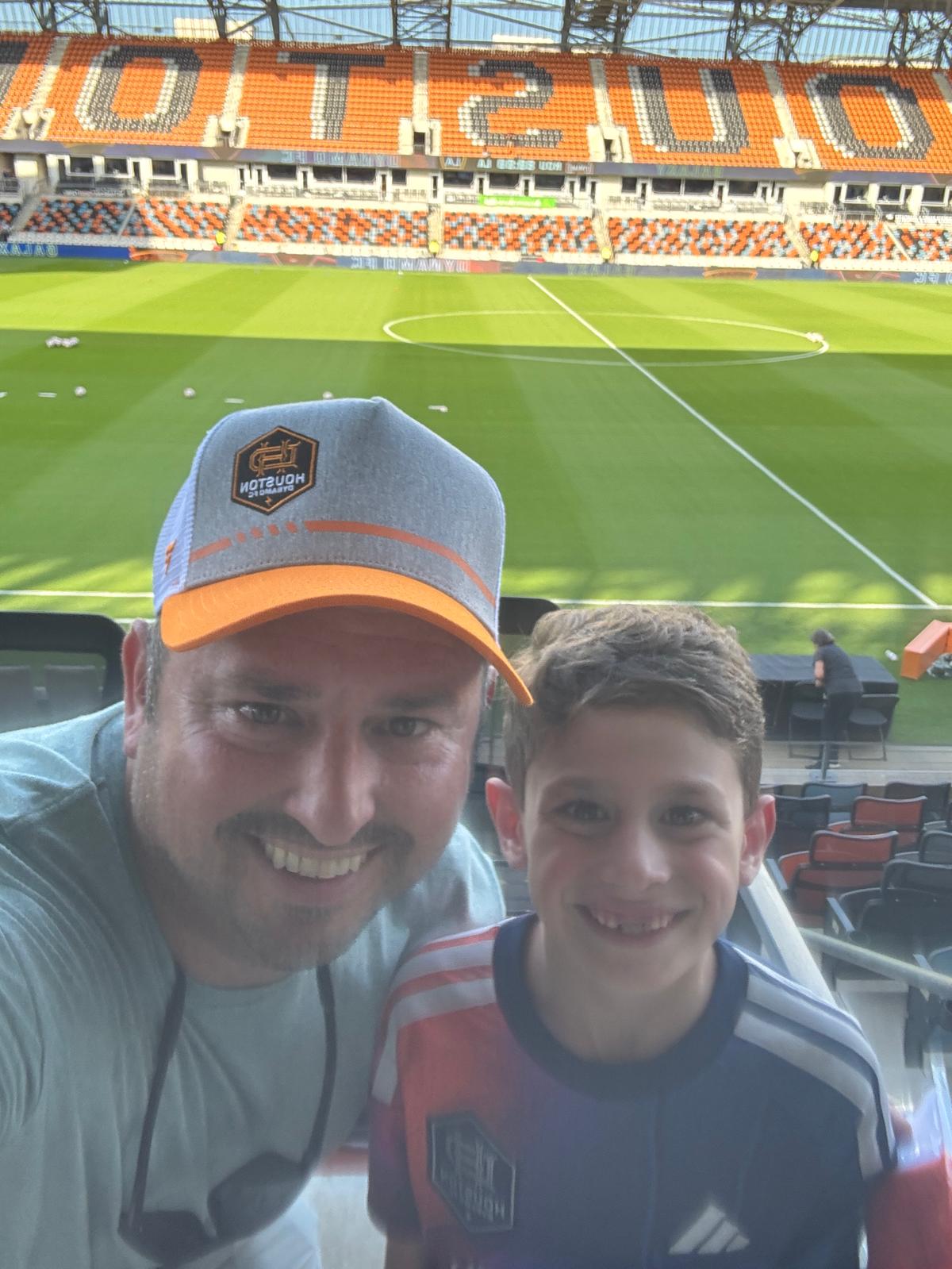 Justin and his son at a soccer match