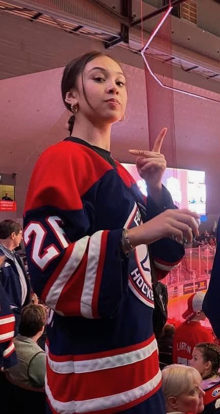 Natalia Moore at a hockey game in her Fox Motors jersey