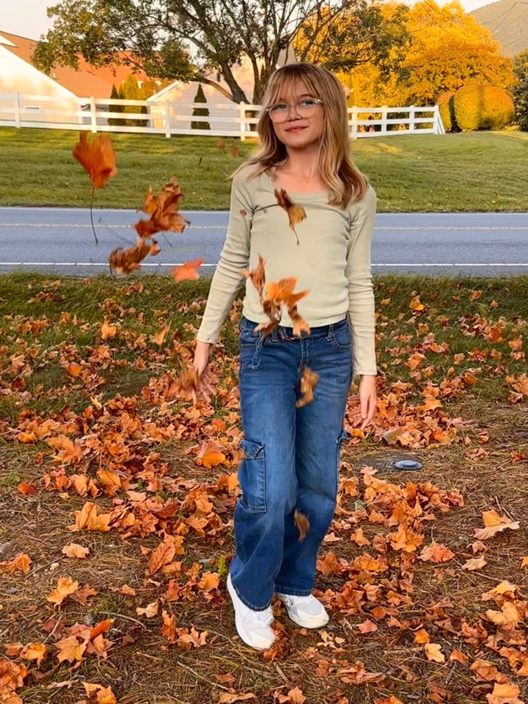 Autumn playing in fall leaves