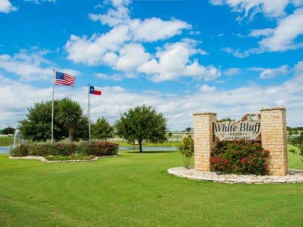 White Bluff Resort entrance sign with American and Texas flags
