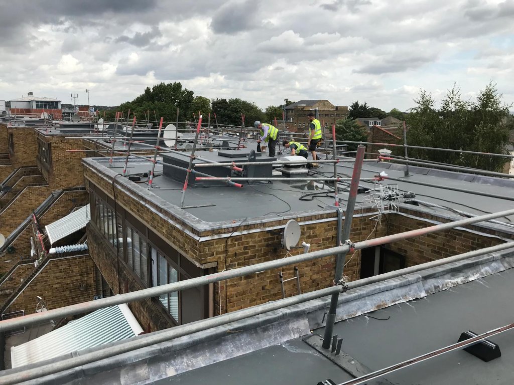 Commercial rooftop HotSpray application in progress — approved applicators applying polyurea membrane