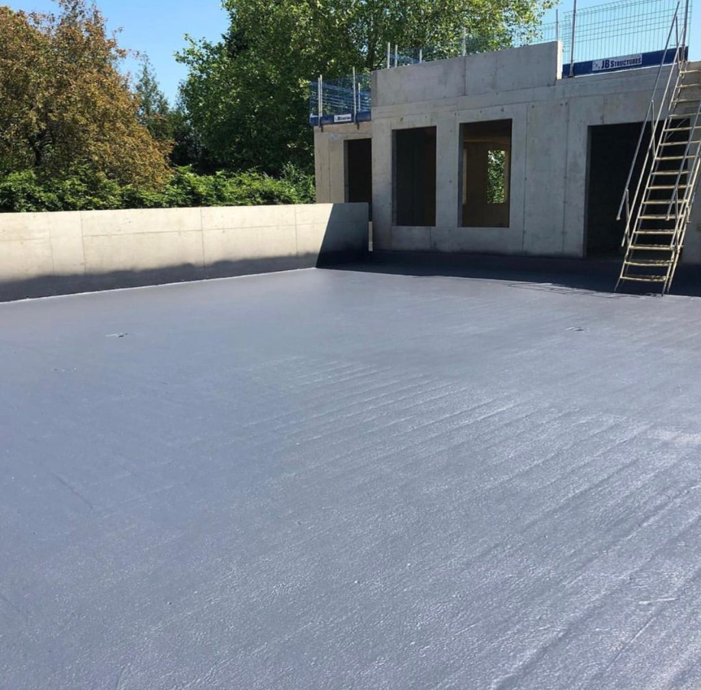 New build commercial building — HotSpray polyurea waterproofing applied across large concrete flat roof area