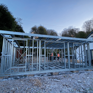 Modern black steel frame garden room with bi-fold doors — example for a Leigh project enquiry