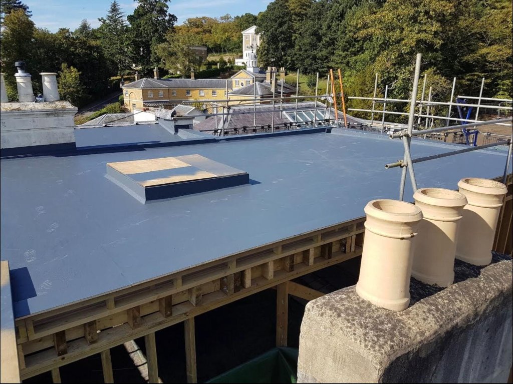 Heritage residential refurbishment — HotSpray membrane across flat roof with rooflight and perimeter upstands, Surrey