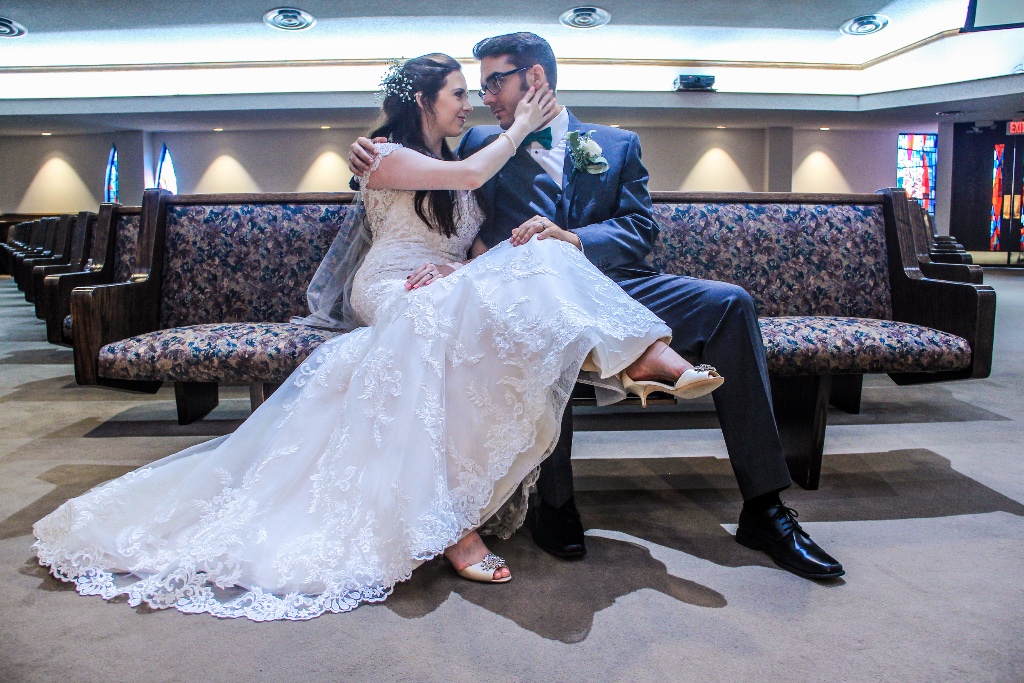 Newly married couple sharing a quiet moment on a church pew in Norman, Oklahoma