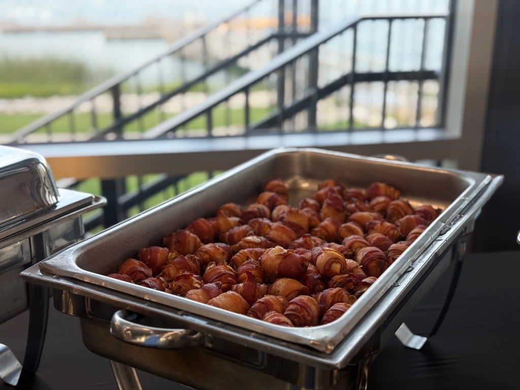 Bacon-wrapped chicken brochettes hot from the chafing dish