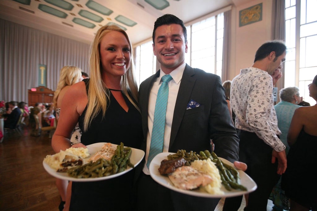 Falcone's catering staff holding plated dinners at the Hall of Mirrors