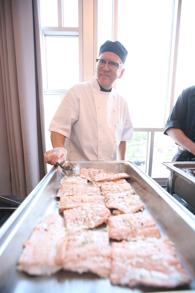 Our on-site chef serving perfectly prepared fish from a chafing dish