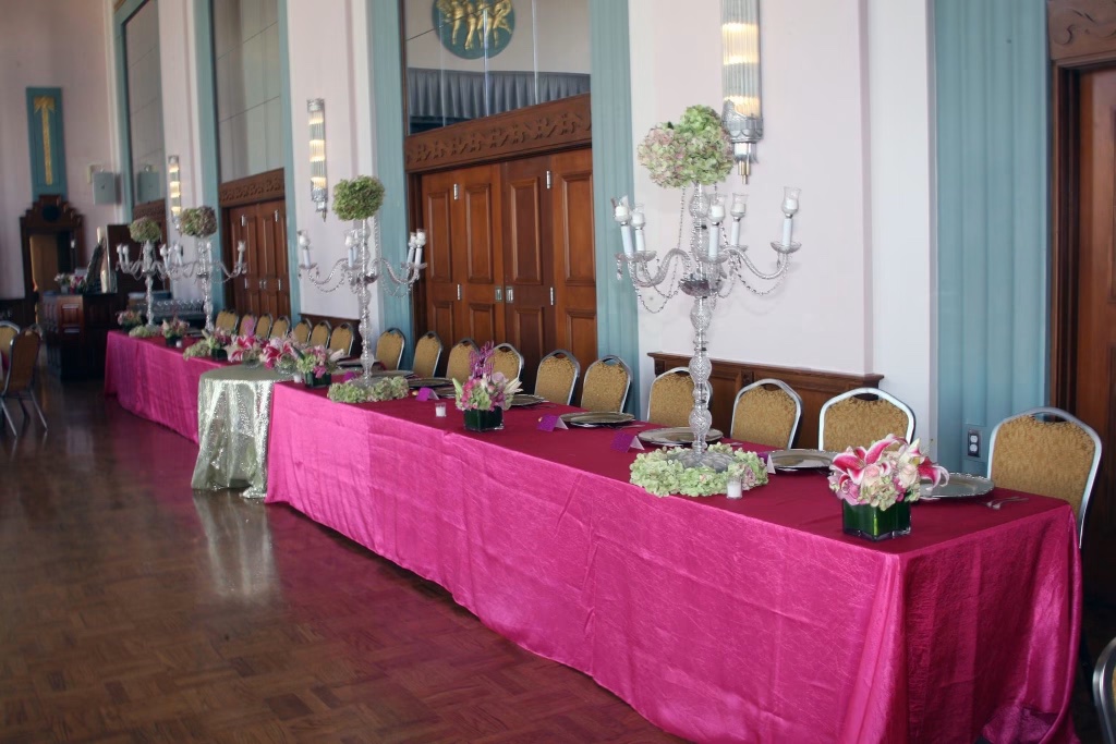 A long banquet table with crystal candelabras and lush pink floral arrangements