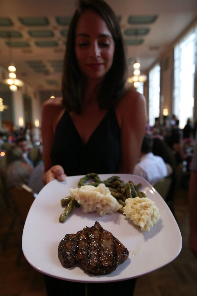 A plated dinner of steak, mashed potatoes, and green beans served at the reception