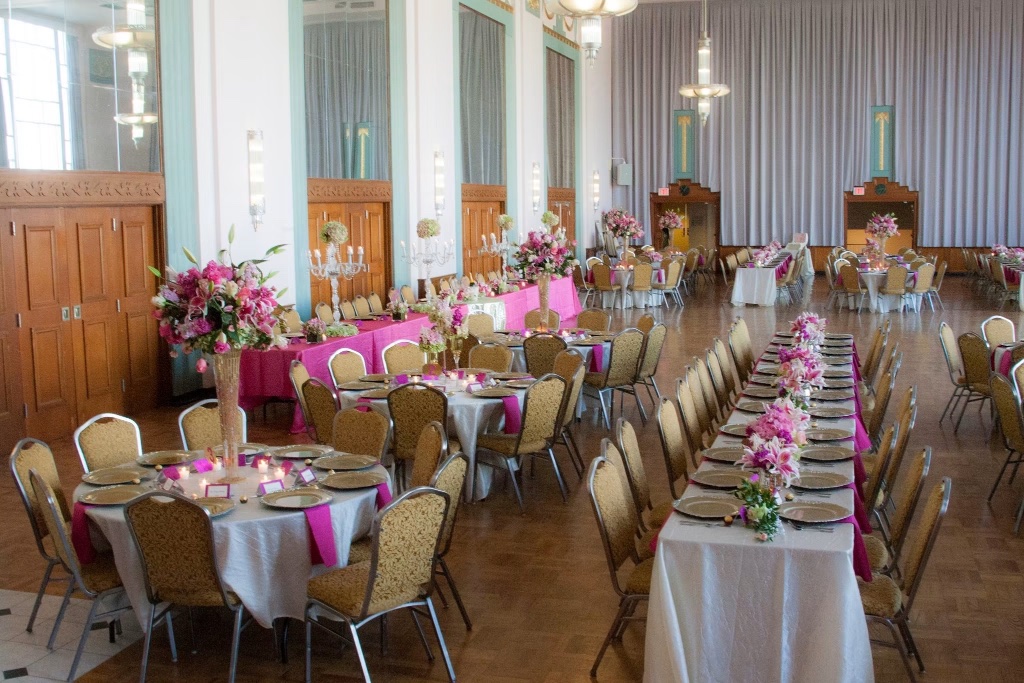 Wide view of the Hall of Mirrors reception with silver linens and pink runners