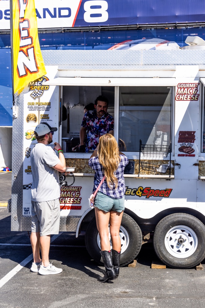 Families enjoying pizza by the trailer