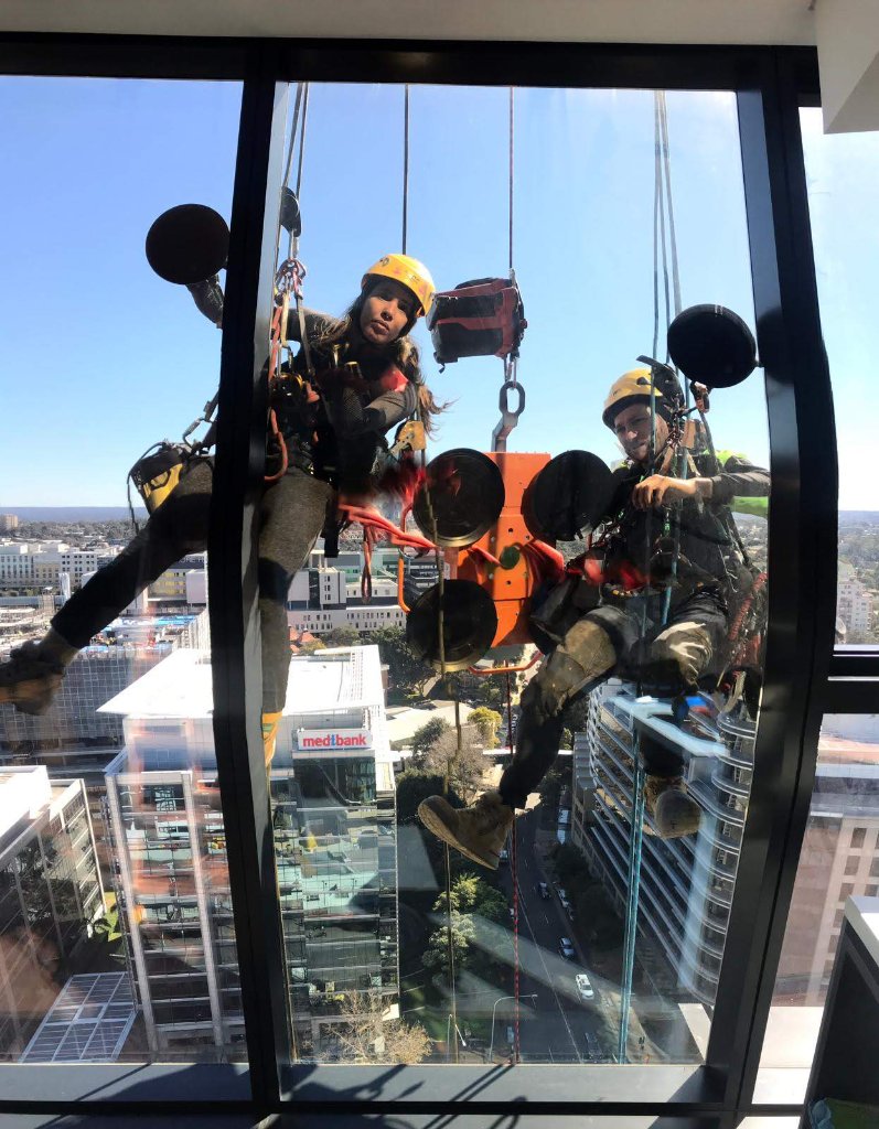 RPM technicians suspended outside high-rise with glass suckers
