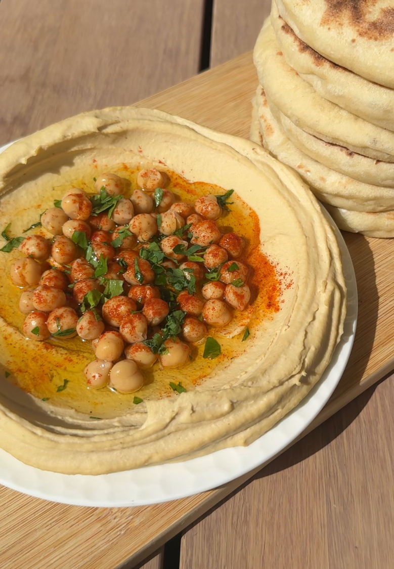 קערת חומוס ביתי קרמי מוגש עם שמן זית
