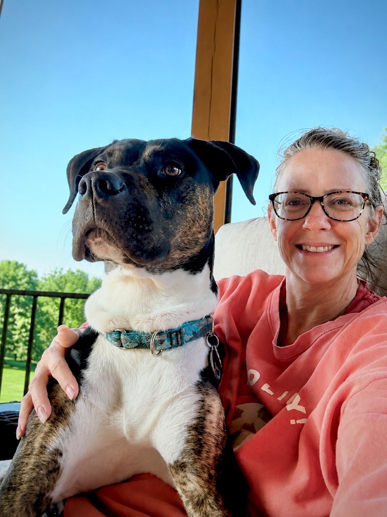 The founder of Pawsitive Messages sitting on the porch with Moose the dog